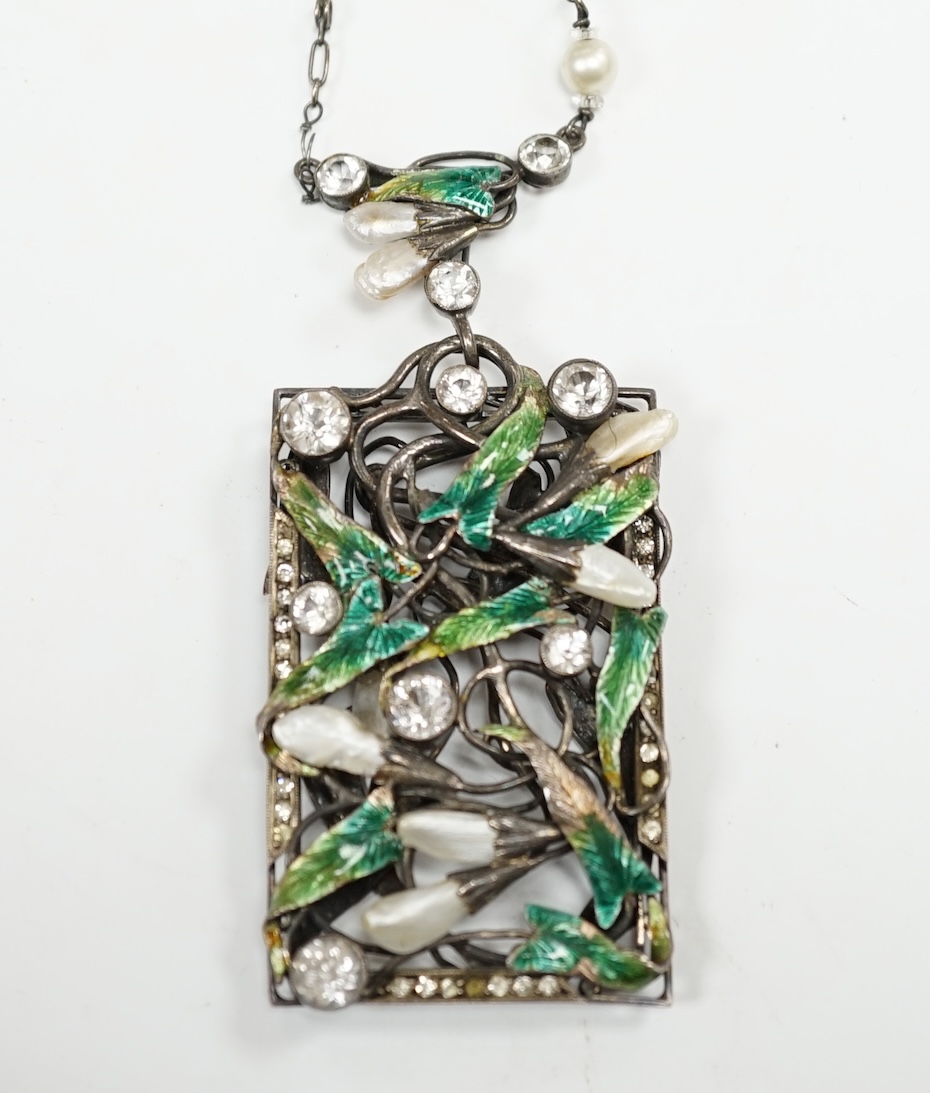 An Arts & Crafts pierced white metal, paste, simulated pearl and enamel set foliate pendant necklace, 70cm. Condition - poor